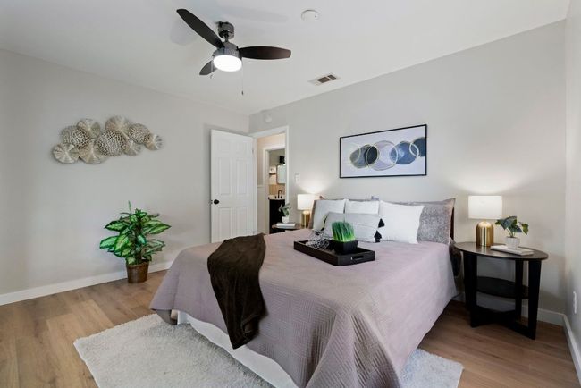 High ceilings, a ceiling fan, and laminate flooring throughout. | Image 11