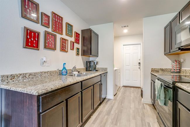 Kitchen looking into utility room. | Image 13
