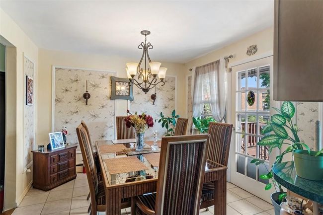 Tiled dining area featuring an inviting chandelier | Image 5