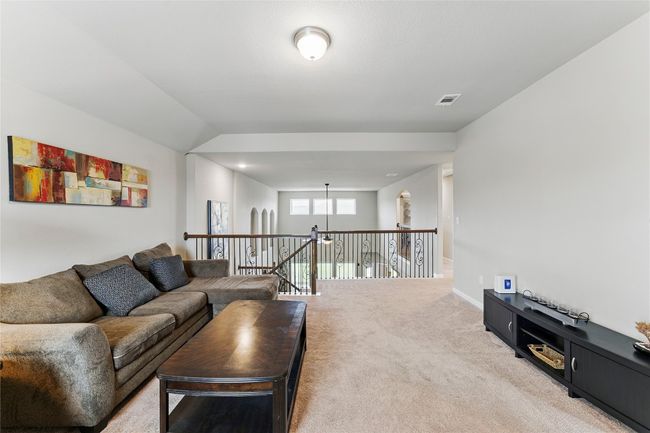 Living room with visible vents, light colored carpet, and baseboards | Image 24