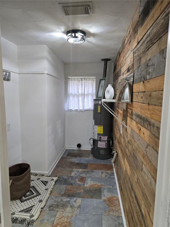 From kitchen you walk into the utility room with NEW hot water heater install 3/25 then off to the left is the Flex space. | Image 30