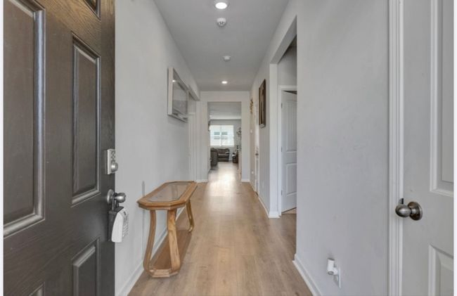 Front bedroom currently being used as a guest room. Bathroom separates both front rooms. | Image 4