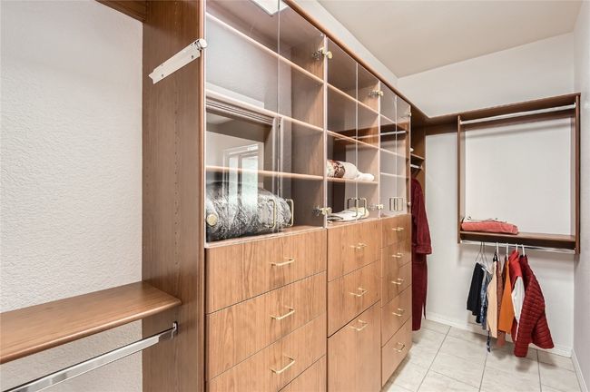 Spacious walk in closed with built in closet system. | Image 13