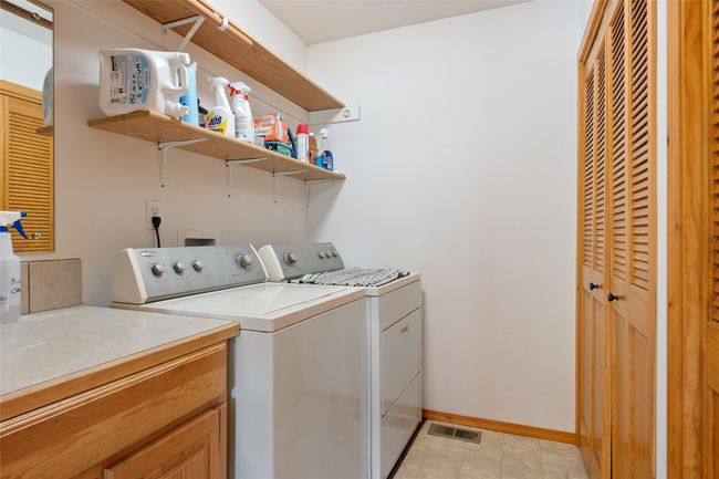 Laundry area with separate washer and dryer and baseboards | Image 37