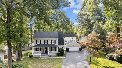 View of front of property featuring a front yard, oversized garage, and country front porch | Image 2