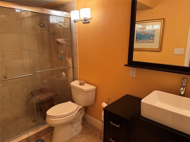 Bathroom with vanity, a stall shower, and tile patterned flooring | Image 13