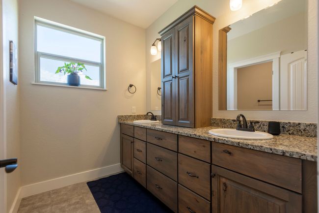 Bathroom featuring double vanity and baseboards | Image 21