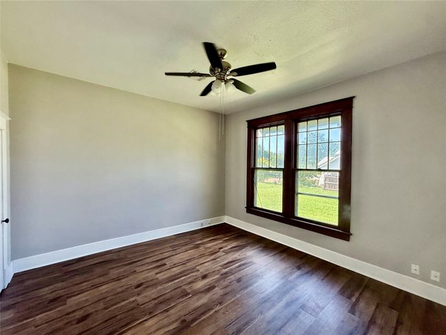 Empty room featuring dark wood-style floors and ceiling fan | Image 11