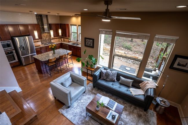 Living area with a ceiling fan, light wood-style floors, and recessed lighting | Image 14