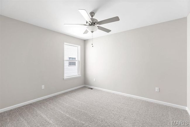 Empty room featuring a ceiling fan, baseboards, and light carpet | Image 5