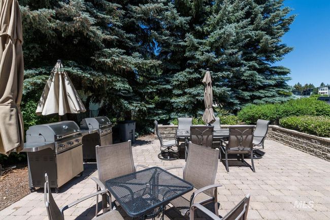 View of patio featuring outdoor dining area and grilling area | Image 17