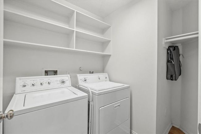 Laundry room off garage with extra hanging storage | Image 33