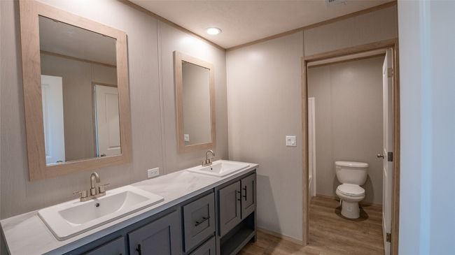 Bathroom featuring wood finished floors, double vanity, and crown molding | Image 13