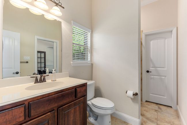 Bathroom featuring baseboards, vanity, and toilet | Image 28