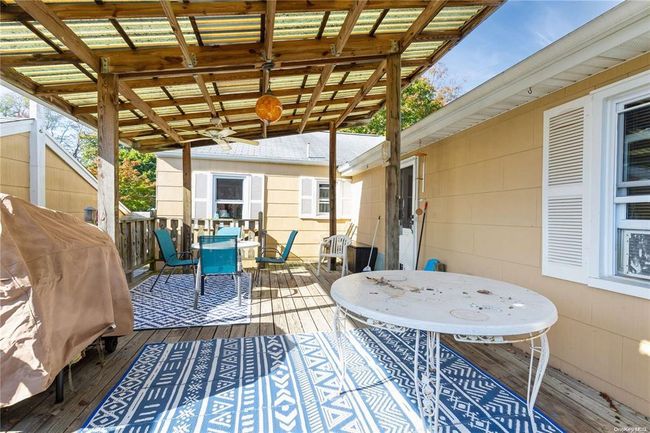 Deck with ceiling fan and outdoor dining area | Image 4