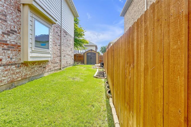 View of yard with a storage unit | Image 40