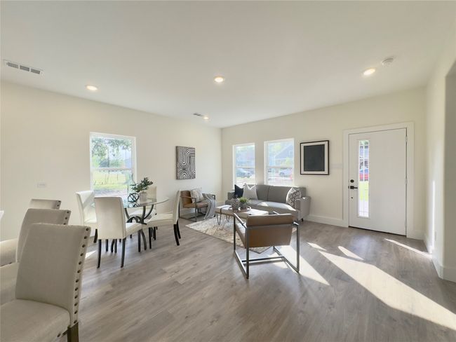 Living area featuring baseboards, visible vents, a healthy amount of sunlight, and light wood-style flooring | Image 5