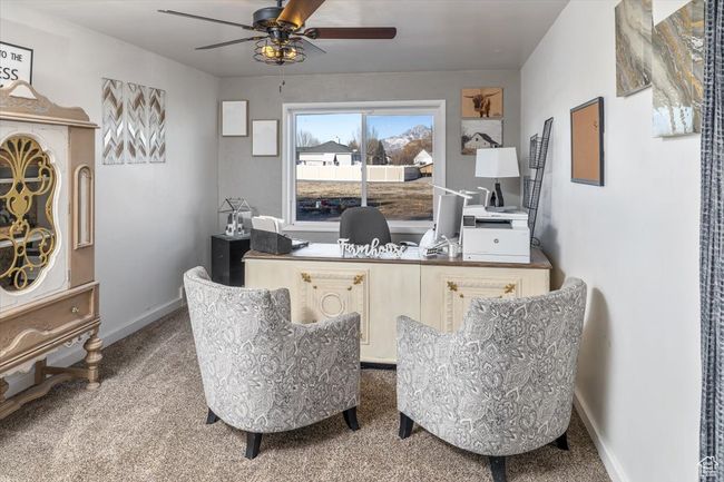 Carpeted office with ceiling fan | Image 17