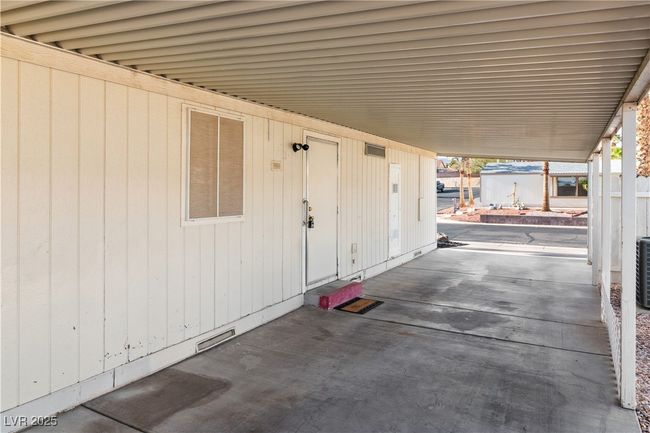 View of patio with an attached carport and visible vents | Image 31