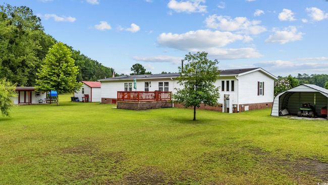 View of yard with a storage shed, a deck, and a patio area | Image 28
