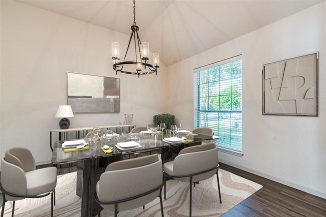 Dining space featuring a chandelier, wood finished floors, and lofted ceiling | Image 11