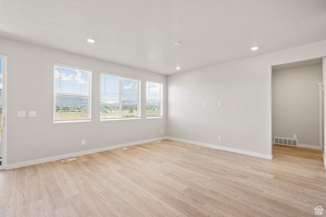 Unfurnished room featuring light wood finished floors, baseboards, and recessed lighting | Image 17