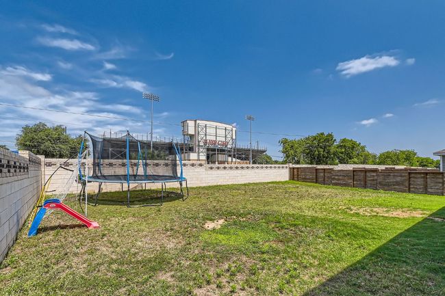 Fenced backyard with a trampoline | Image 28
