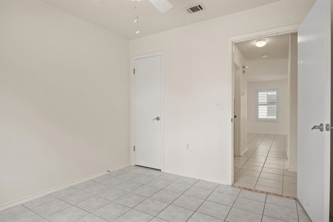 room with light tile patterned floors and a ceiling fan | Image 24