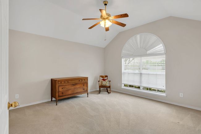Sitting room with vaulted ceiling, baseboards, carpet, and a ceiling fan | Image 31