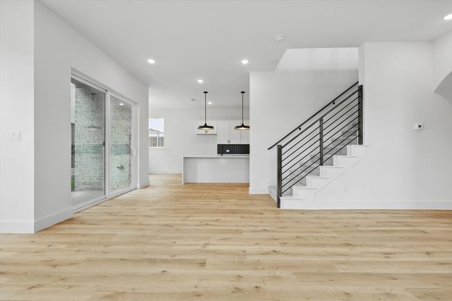 Unfurnished living room featuring light wood-type flooring, baseboards, and recessed lighting | Image 12