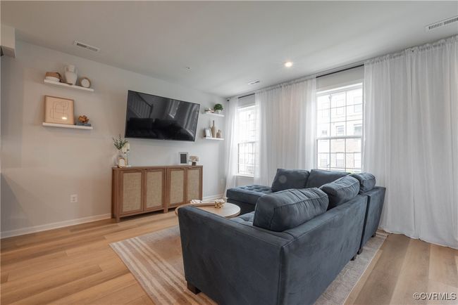 Living area with recessed lighting, visible vents, light wood finished floors, and baseboards | Image 16