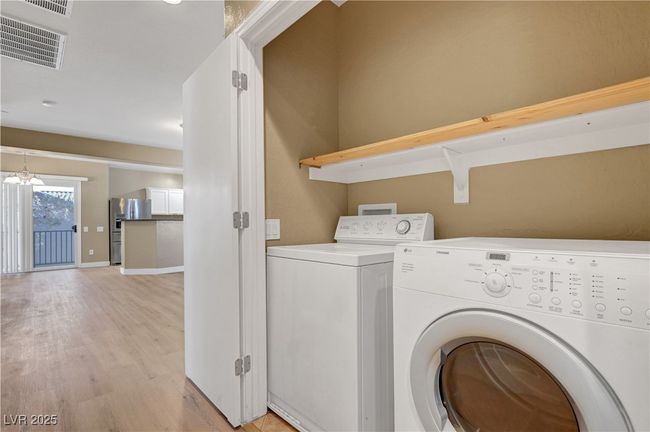Laundry area featuring visible vents, baseboards, washer and dryer | Image 23