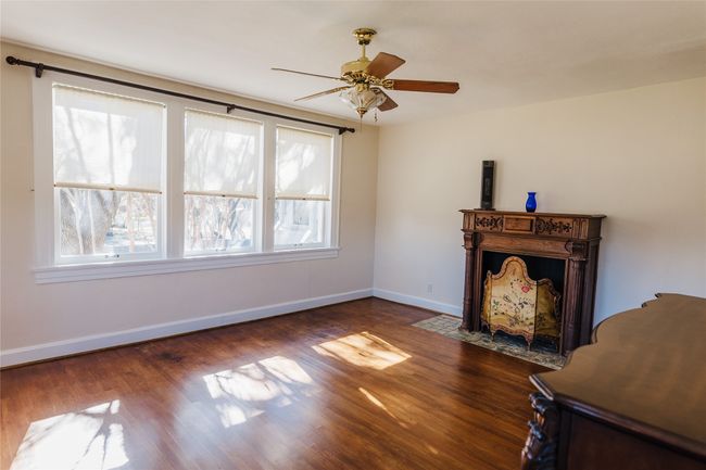 Unfurnished living room featuring ceiling fan and dark hardwood / wood-style floors | Image 33