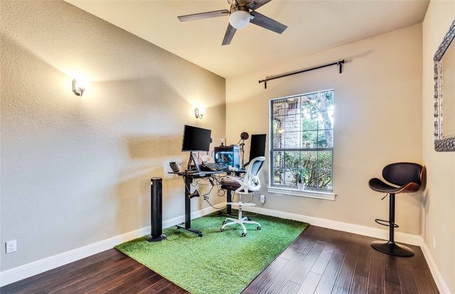 Bedroom used as office with wood finished floors and a ceiling fan | Image 14