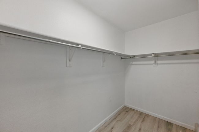 The spacious walk-in closet in the primary suite offers plenty of room for storage. | Image 19
