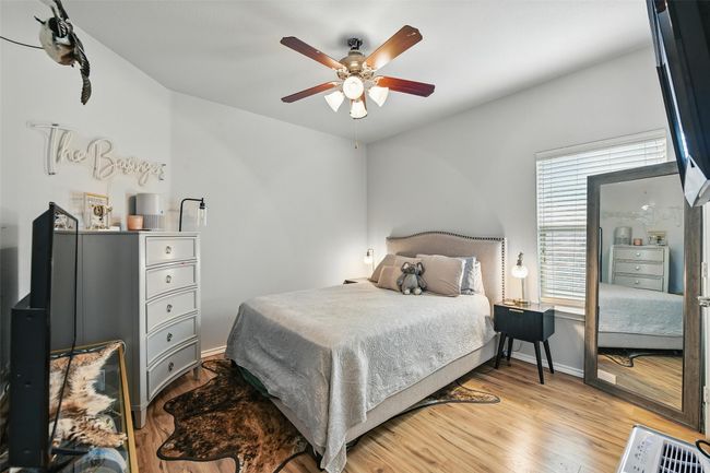 Bedroom with wood finished floors and a ceiling fan | Image 37