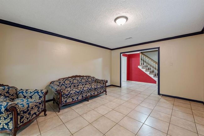 To the left is a spacious tiled room that can be purposed in many ways---a music room, a playroom, an office, or whatever suits your lifestyle. | Image 4