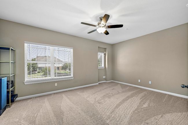 Media room with carpet floors and a ceiling fan | Image 24