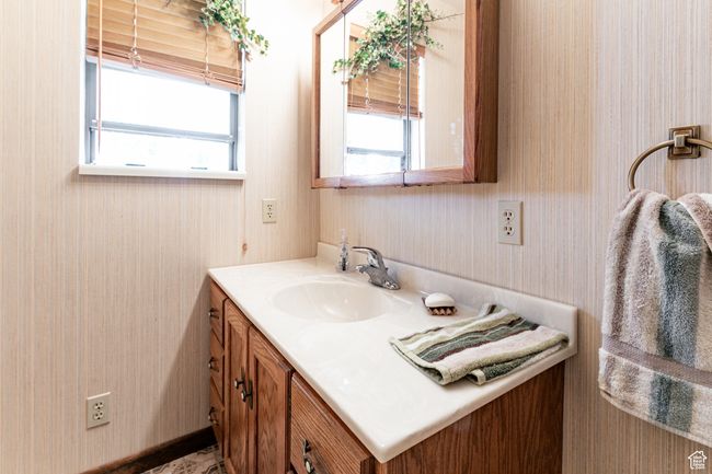 Bathroom with vanity and wallpapered walls | Image 9