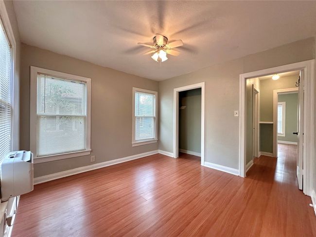 Unfurnished bedroom with light wood finished floors, a ceiling fan, and a closet | Image 14