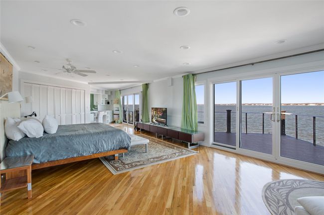 Bedroom featuring access to exterior, crown molding, wood finished floors, and recessed lighting | Image 6