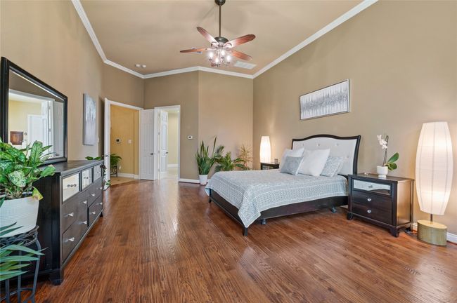 Bedroom with wood finished floors, crown molding, and ceiling fan | Image 21