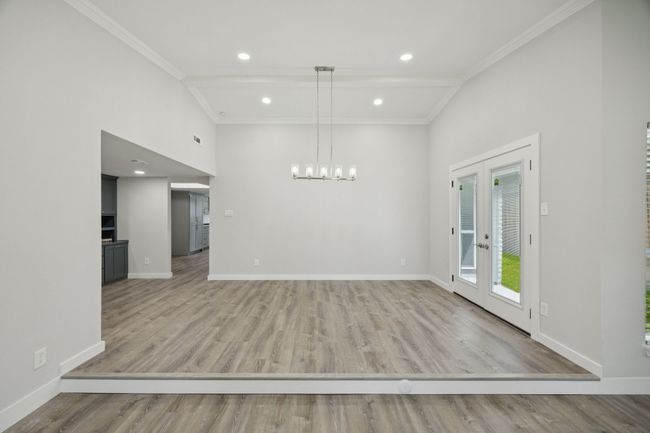 This view of the Formal Dining also shows the openness to the Custom Built in Home Office area and the kitchen | Image 11