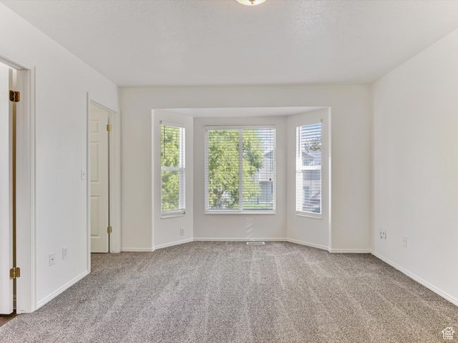 Carpeted empty room featuring baseboards | Image 7