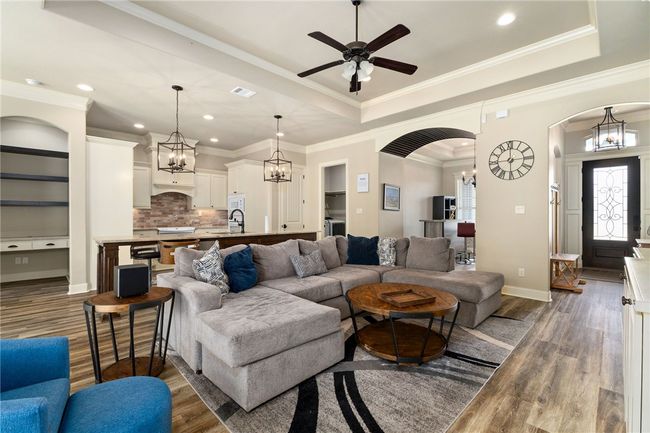Ample space here comfortably fits a sectional or a sofa and loveseat combination. This view also highlights the open layout—ideal for entertaining friends and family. | Image 7