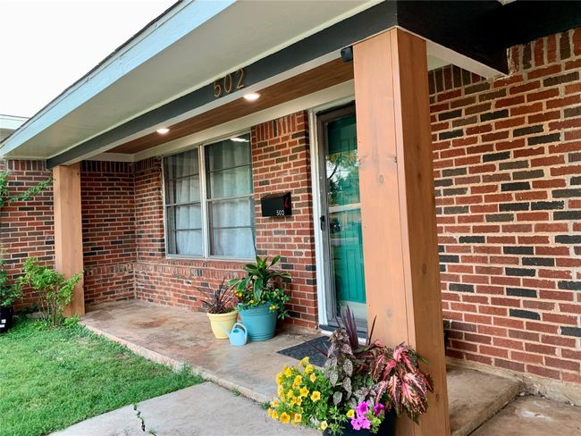 View of exterior entry featuring brick siding | Image 15