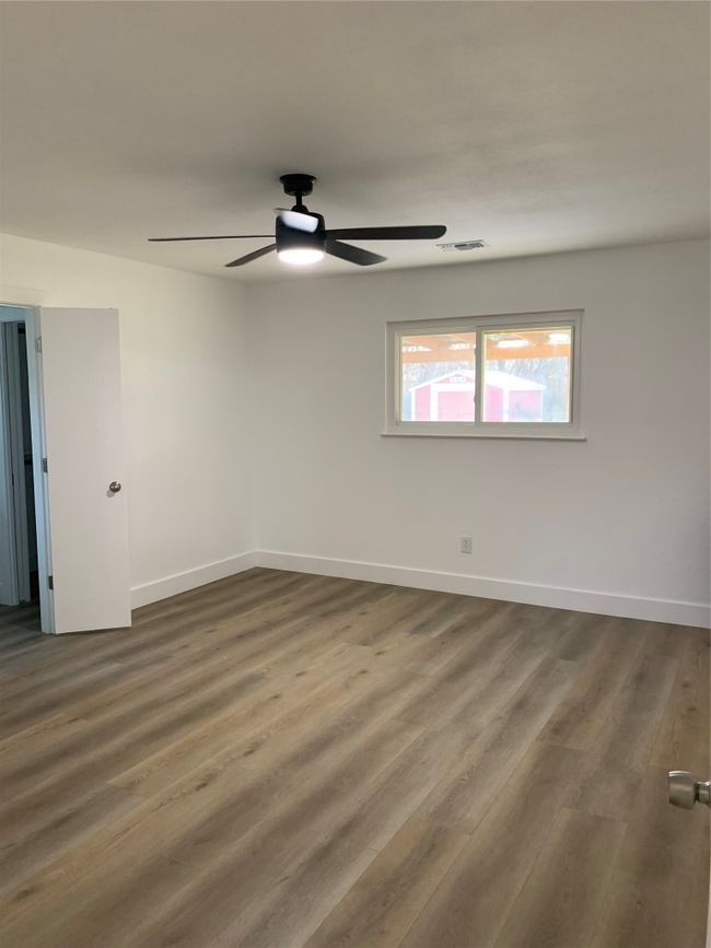 Unfurnished room with ceiling fan and dark wood finished floors | Image 10
