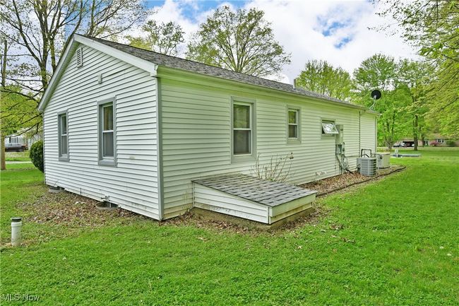 Rear view of house featuring central AC unit and a lawn | Image 44