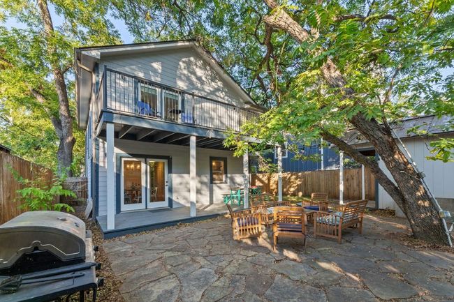 Rear view of house featuring a fenced backyard, a patio area, a balcony, and french doors | Image 17