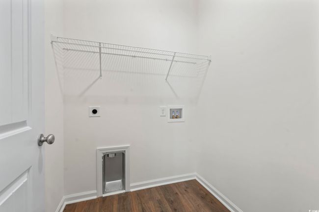 Laundry room featuring hookup for a washing machine, hookup for an electric dryer, dark wood-style flooring, and baseboards | Image 11